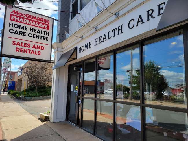 Small storefront with large exterior windows and Home Health Care & Macquarries Pharmasave signage out front