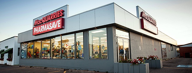 White and grey building with Macquarrie's Pharmasave signage out front