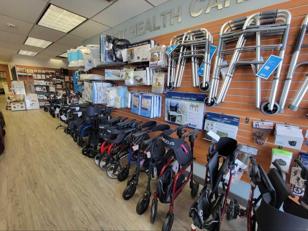 Interior wall of home health care store showing multiple types of walkers and other mobility devices