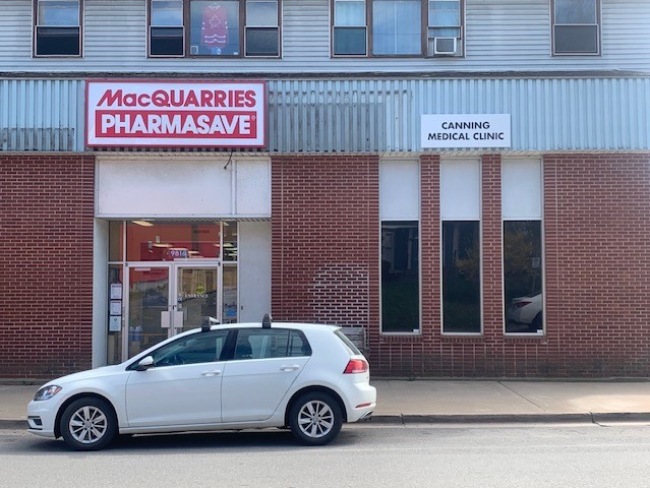 Car parked infront of a pharmacy